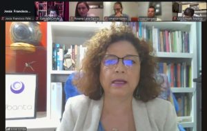 mujer cabello rizado con lentes sentada