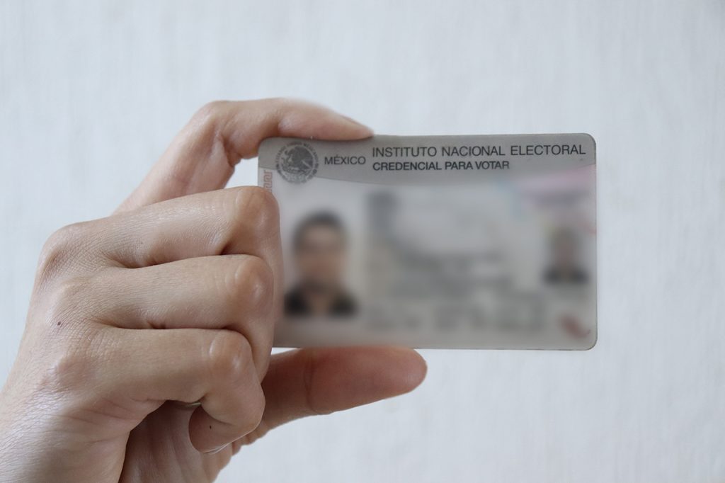 Una mano sosteniendo una credencial para votar