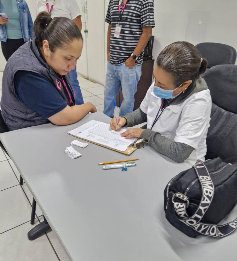 una enfermera tomando los datos de una mujer