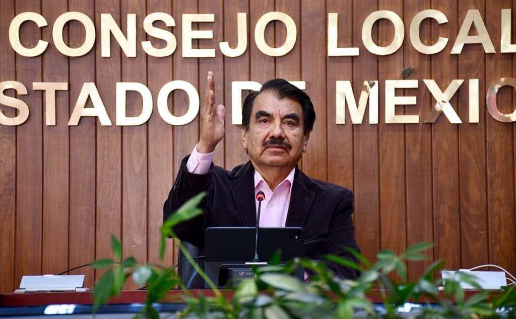 hombre de bigote sentado votando a mano alzada