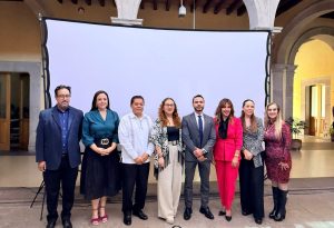 ocho personas de pie posando para la fotografía oficial