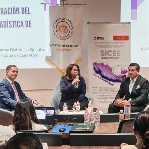 una mujer hablando a través de un micrófono, dos hombres de cada lado