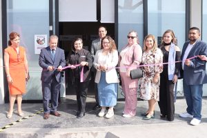 varias personas sosteniendo un listón rosa