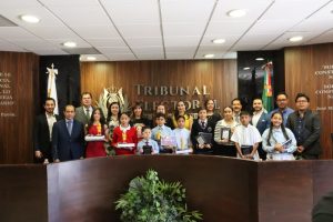 varias personas menores de pie junto a personas adultas
