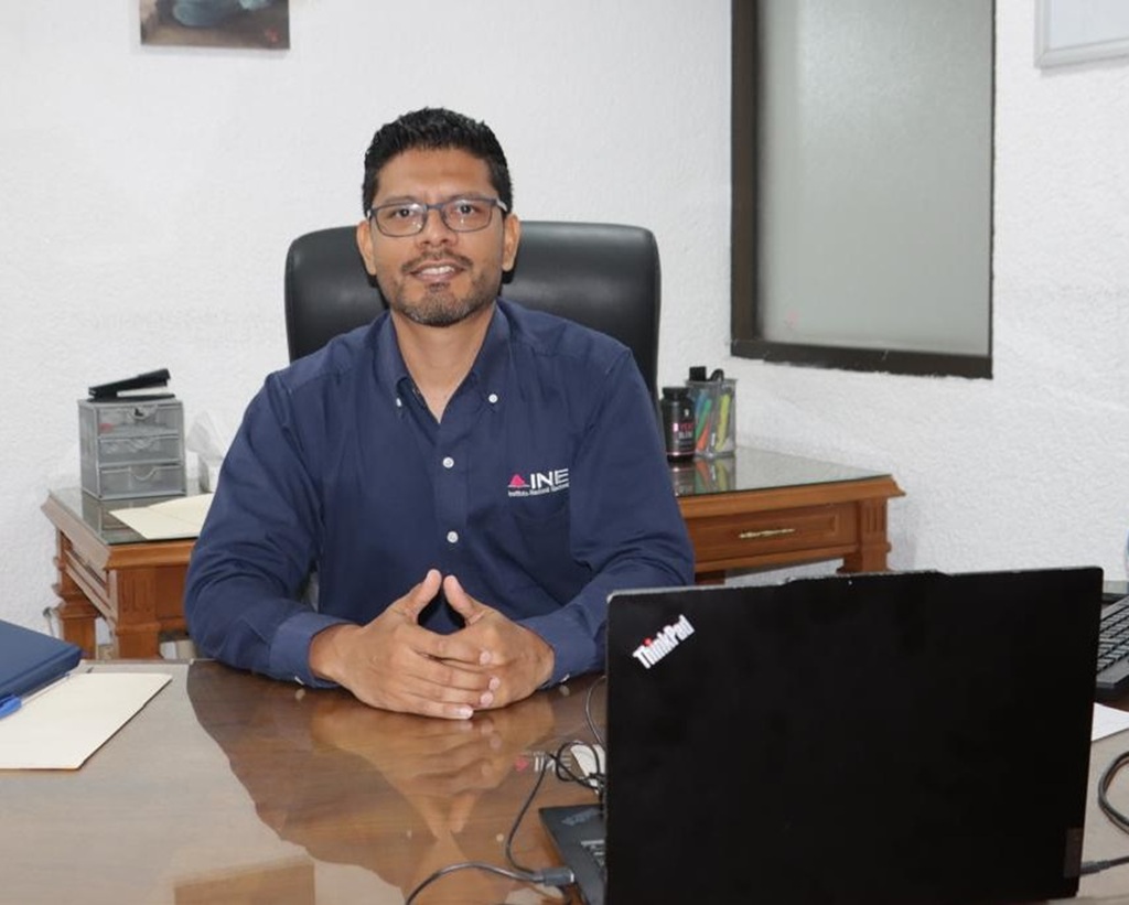 un señor sentado frente a una computadora