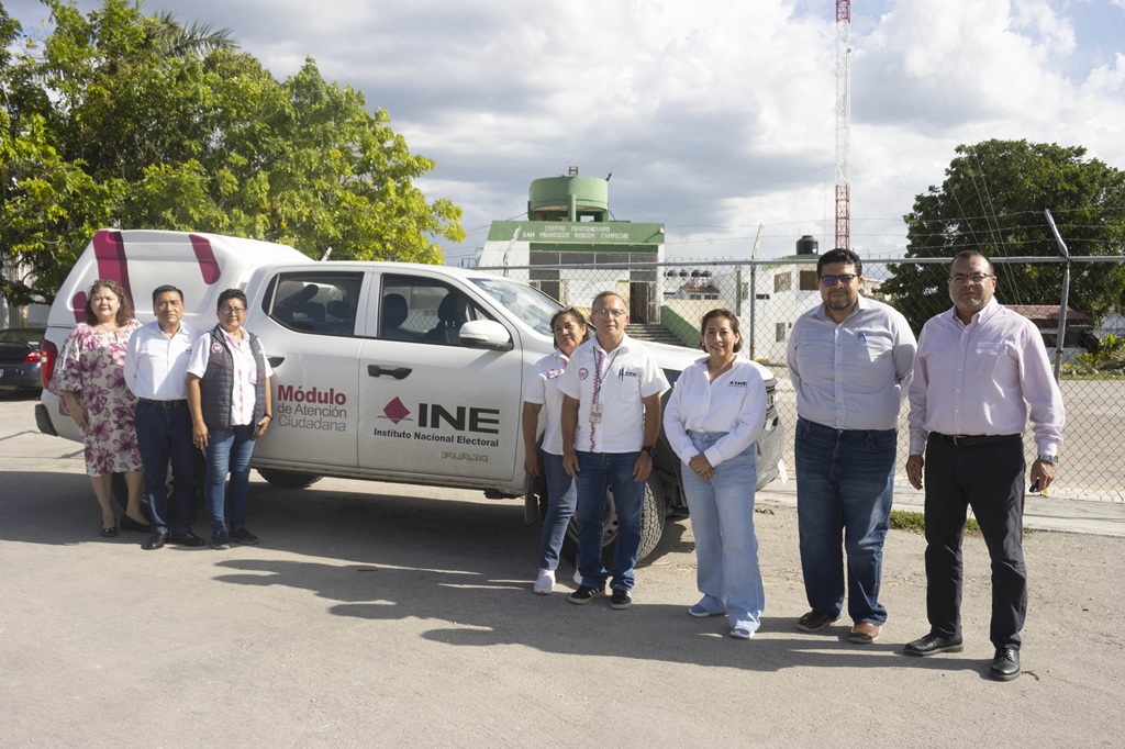 Personas funcionarias del INE en campeche de pie a un lado de camioneta blanca
