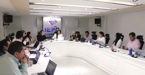 Personas reunidas en una salón blanco