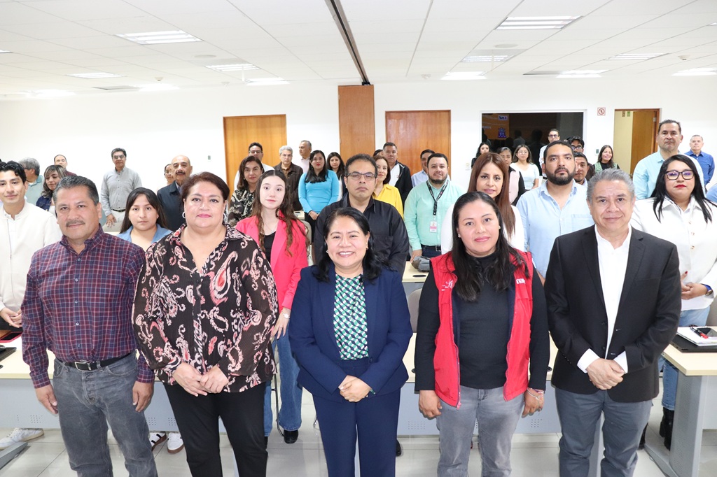 varias personas de pie en un salón posado para la foto