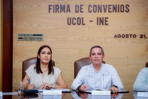 una mujer y un hombre sentados con documentos en la mesa